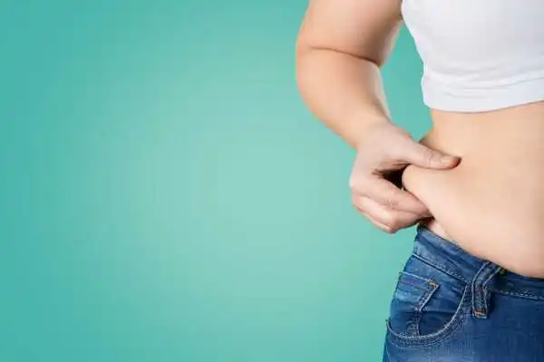 Image of woman pinching her love handles to show weight gain Craiglockhart
